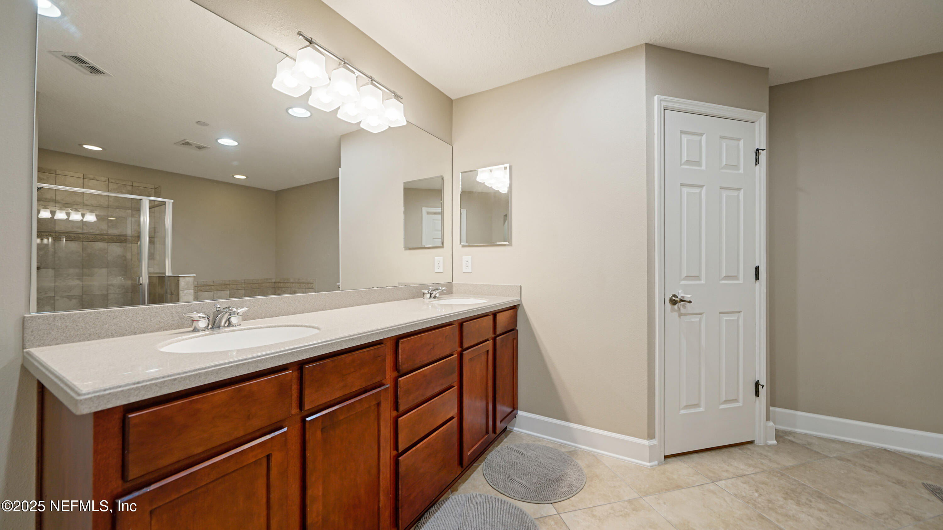 6127 Eclipse Circle Jacksonville, FL 32258 - Photo 21 of 37 a bathroom with a sink double vanity and a mirror