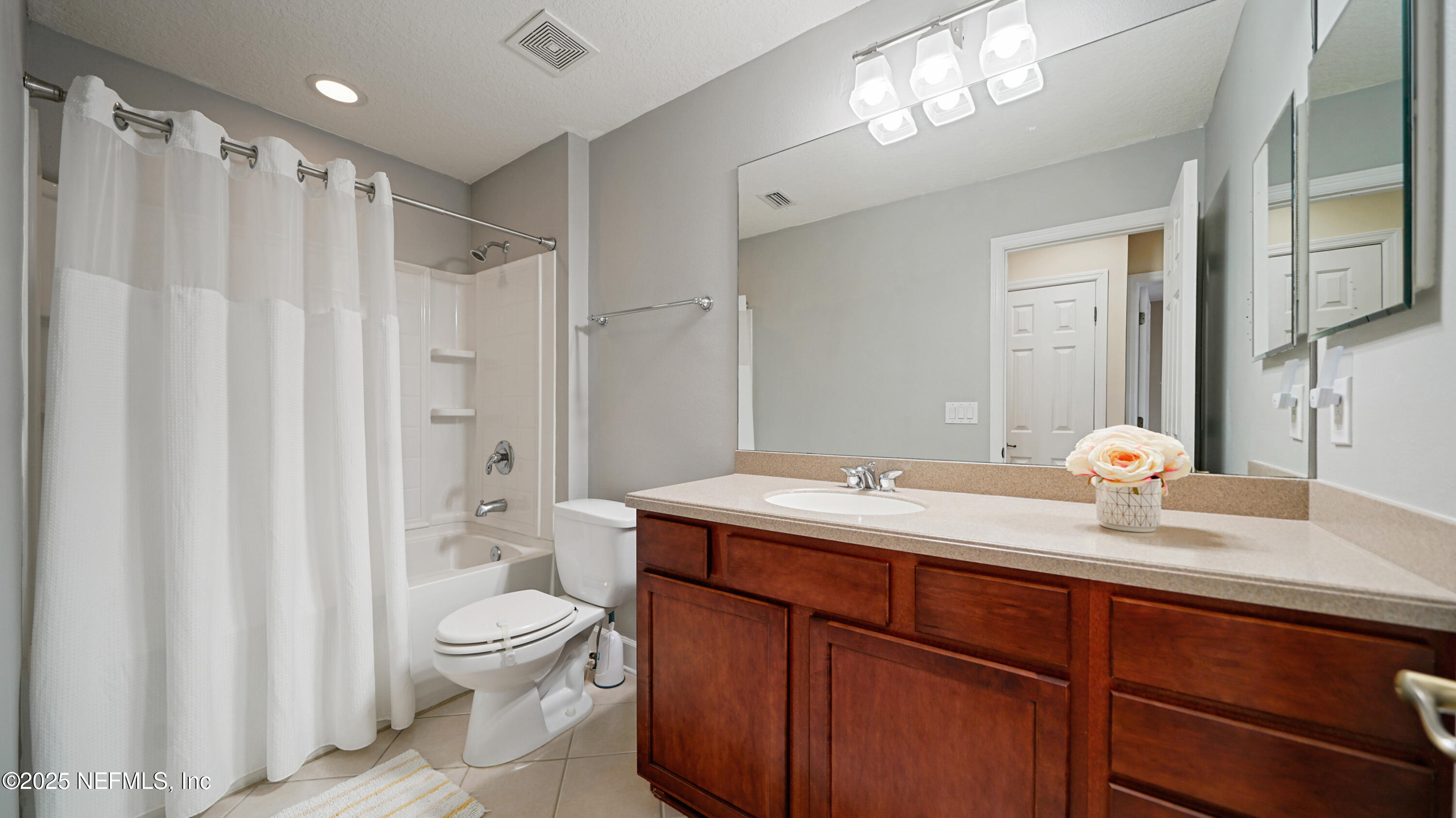 6127 Eclipse Circle Jacksonville, FL 32258 - Photo 25 of 37 a bathroom with a double vanity sink toilet mirror and shower