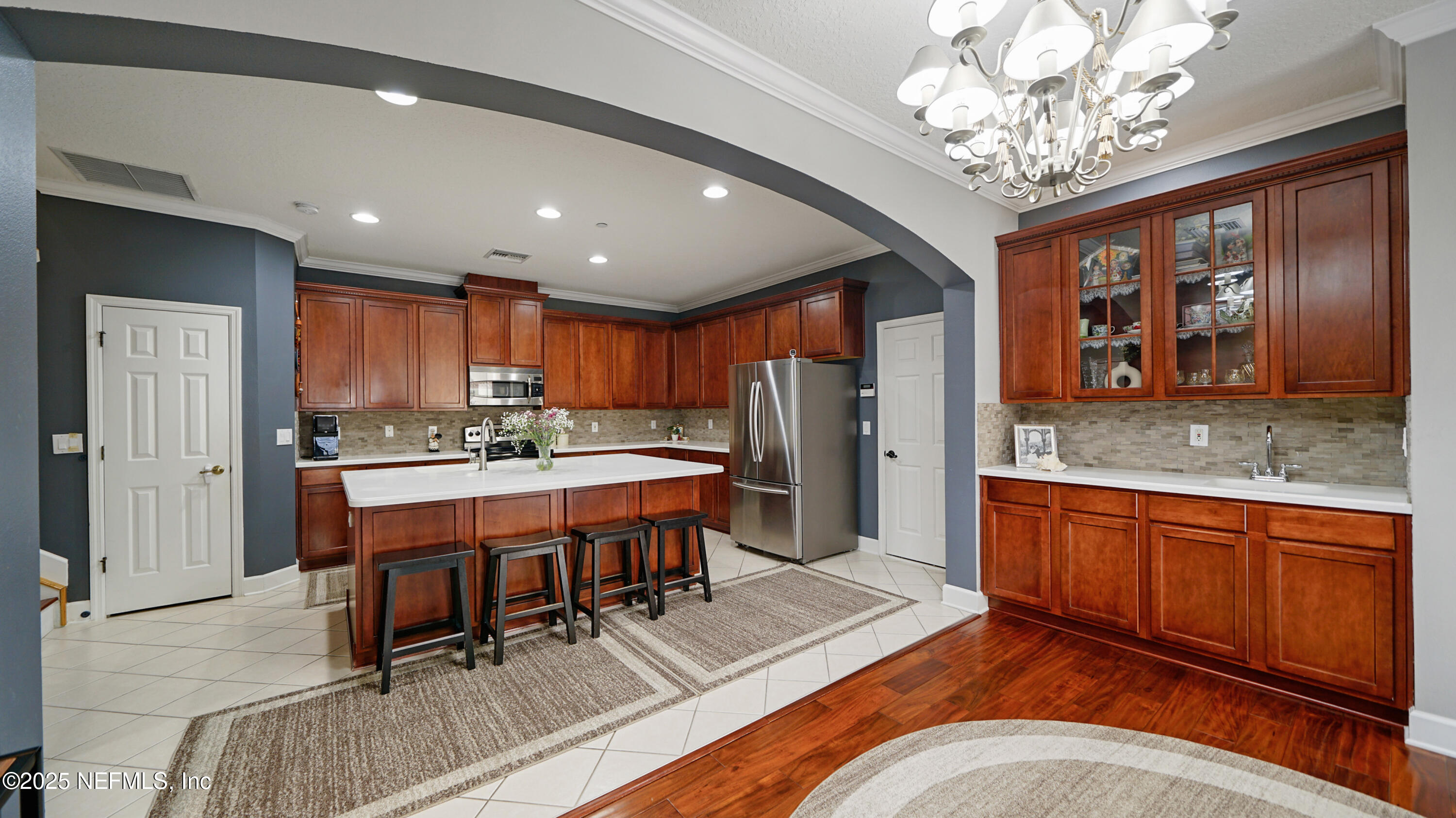 6127 Eclipse Circle Jacksonville, FL 32258 - Photo 4 of 37 a kitchen with stainless steel appliances granite countertop a refrigerator a sink dishwasher a dining table and chairs with wooden floor