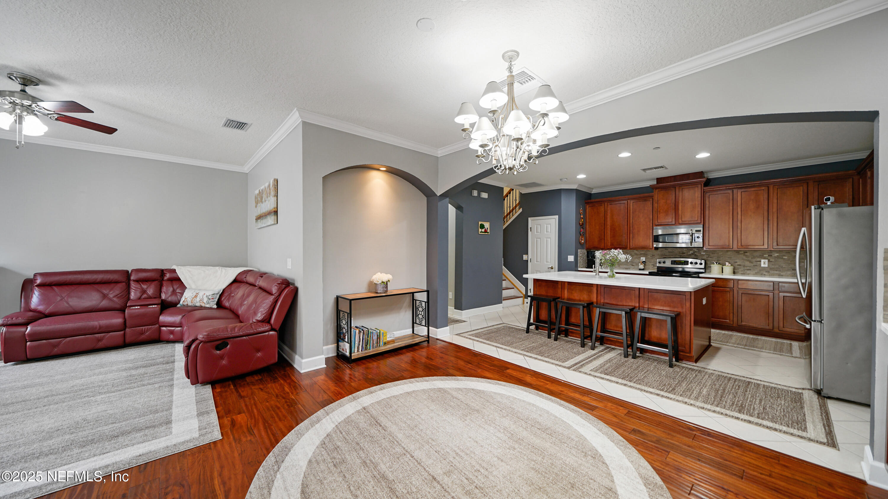 6127 Eclipse Circle Jacksonville, FL 32258 - Photo 5 of 37 a living room with furniture kitchen view and a chandelier
