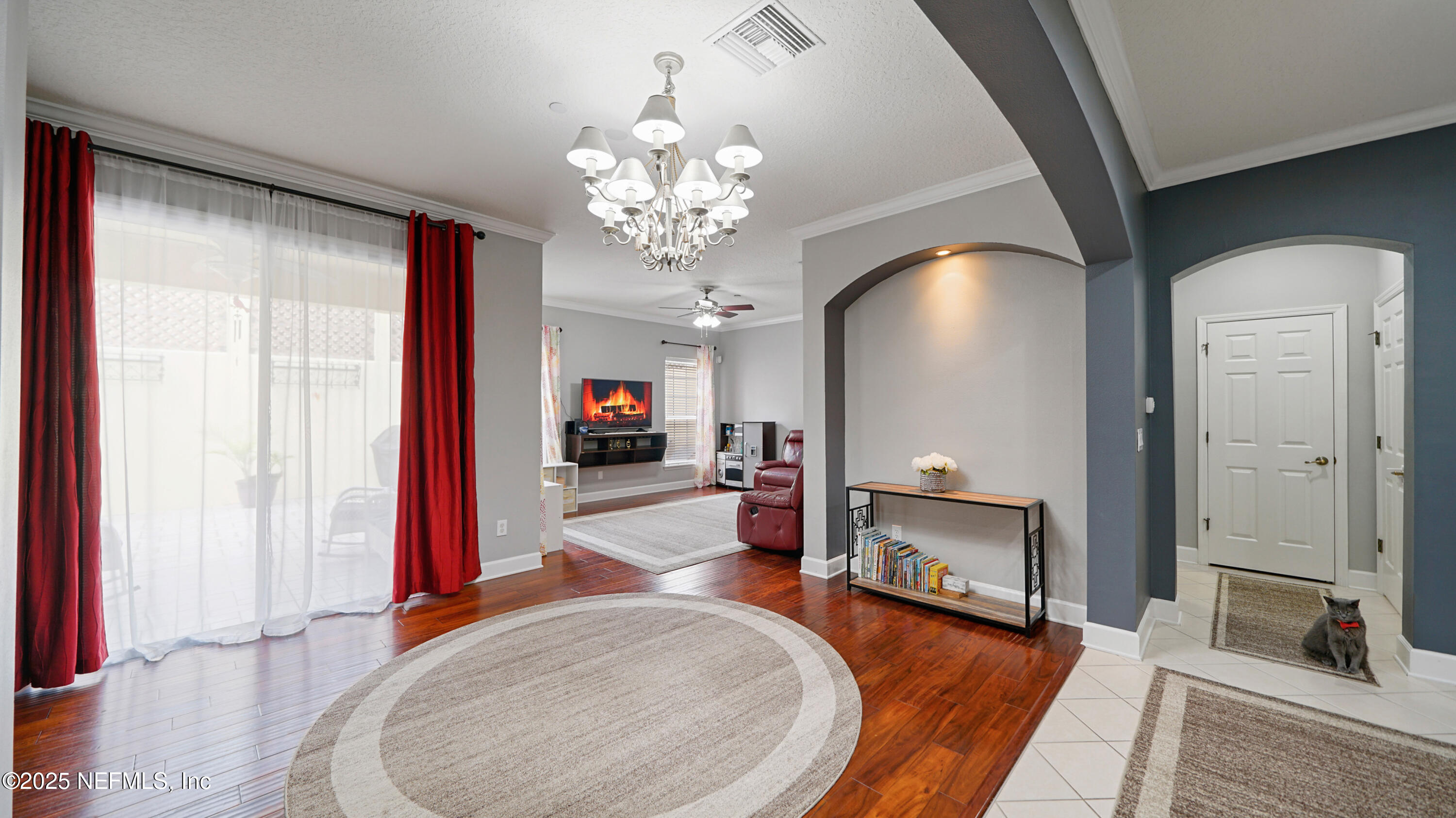 6127 Eclipse Circle Jacksonville, FL 32258 - Photo 9 of 37 a view of a livingroom with a fireplace a chandelier and wooden floor