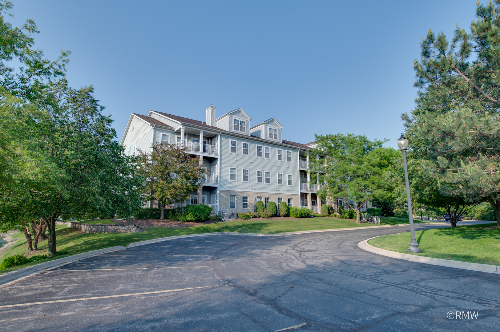 1259 West Lake Street, Unit 304 Addison, IL 60101 - Photo 34 of 43 a view of a big building with a big yard and large trees