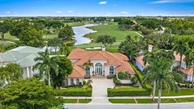 an aerial view of residential houses with outdoor space and river