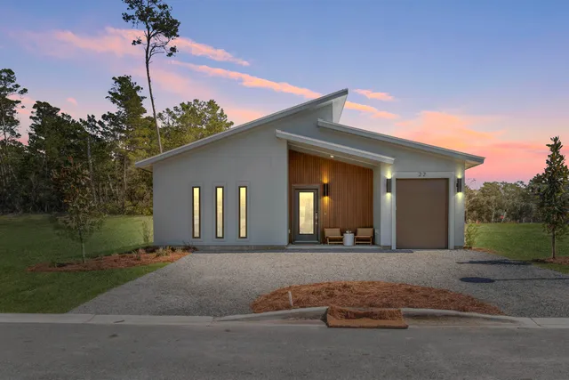 a view of a house with a yard and garage