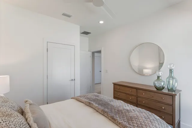 a bedroom with a bed and a mirror