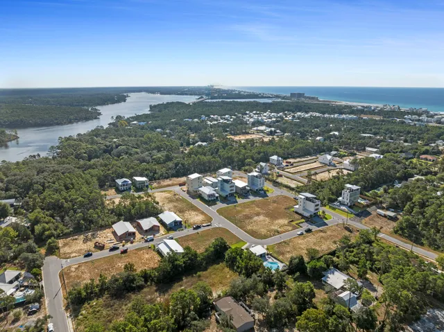 an aerial view of a city with lots of residential buildings and mountain view in back