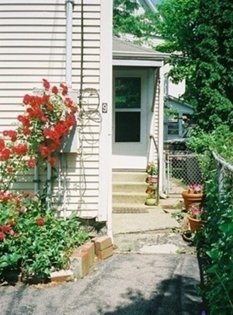 9 Crescent Square Newton, MA 02458 - Photo 3 of 12 a front view of a house with a garden