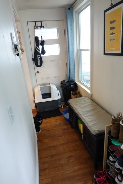 9 Crescent Square Newton, MA 02458 - Photo 5 of 12 a hallway with a table and a window