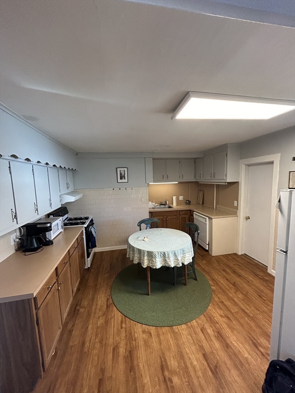 9 Crescent Square Newton, MA 02458 - Photo 6 of 12 a bedroom with a bed and a view of kitchen