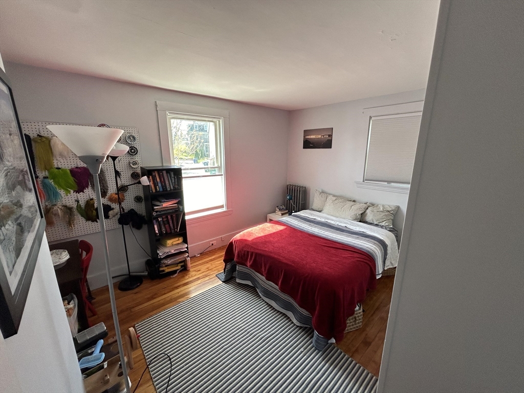 9 Crescent Square Newton, MA 02458 - Photo 9 of 12 a bedroom with bed a chair and a window