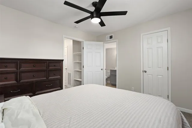 a bathroom with a granite countertop toilet sink and mirror