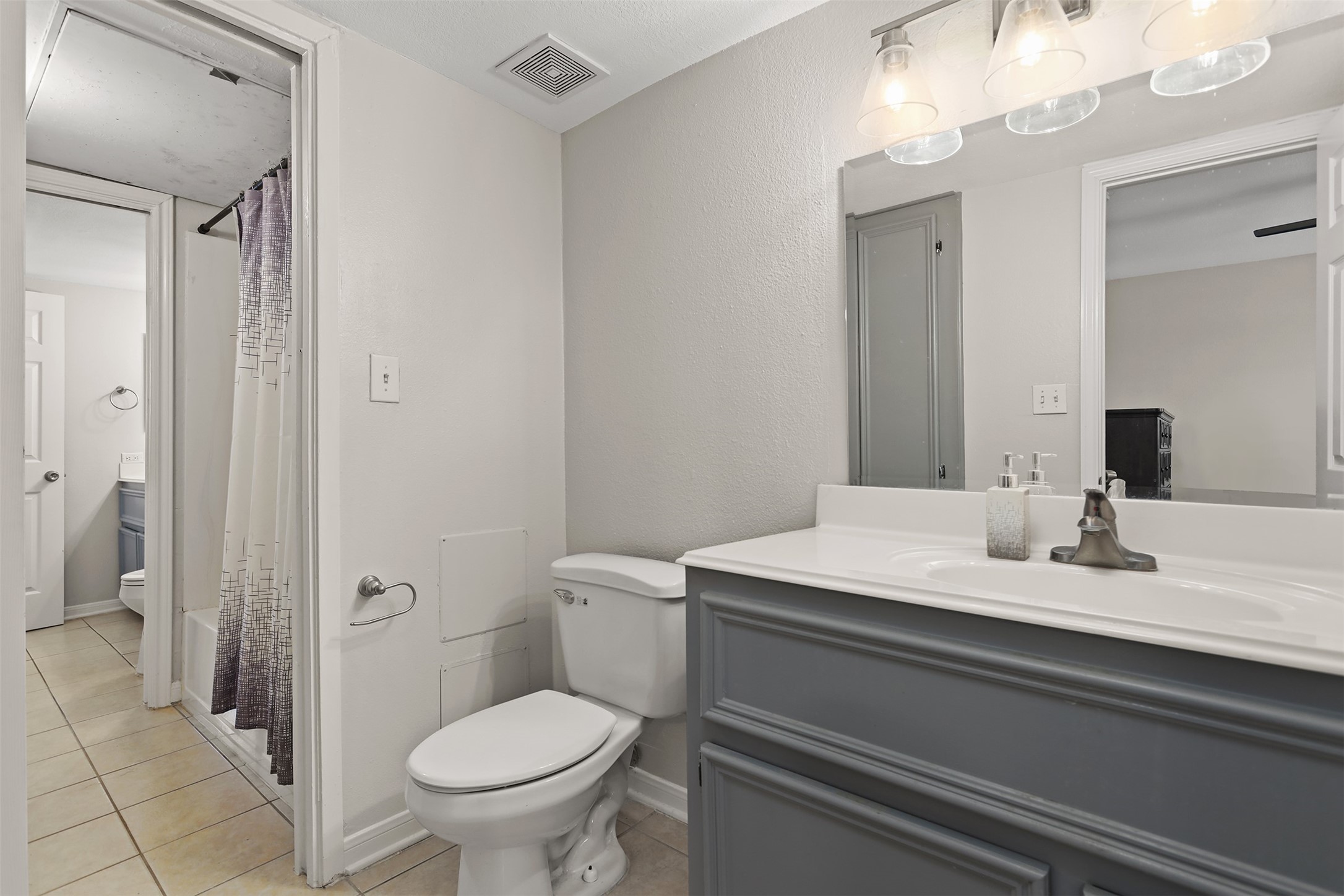 215 Postoffice Street, Unit 1208 Galveston, TX 77550 - Photo 12 of 19 a bathroom with a granite countertop toilet sink and mirror