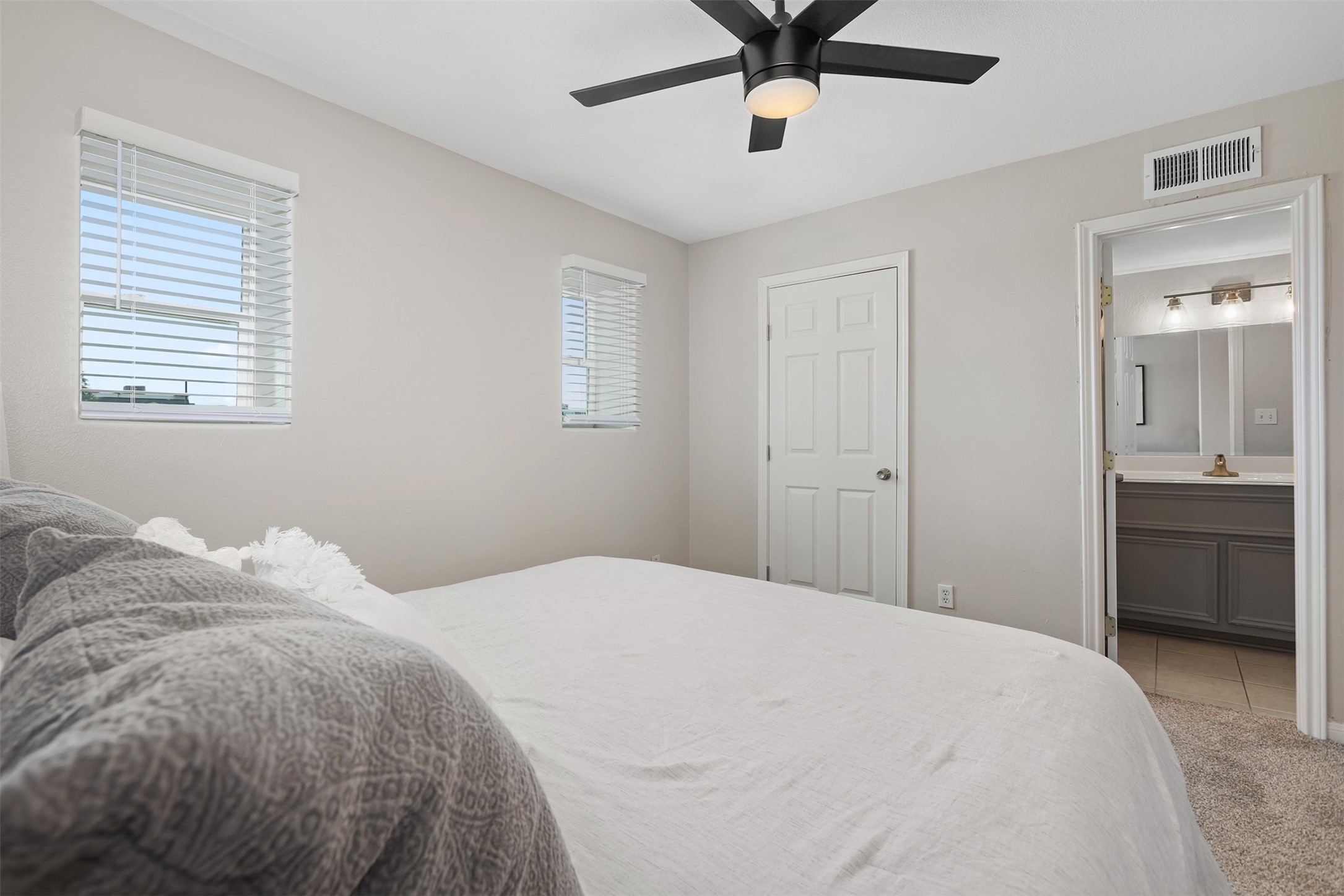 215 Postoffice Street, Unit 1208 Galveston, TX 77550 - Photo 14 of 19 a bedroom with a large bed and a chandelier