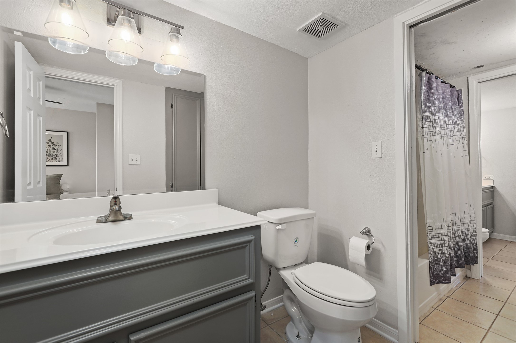 215 Postoffice Street, Unit 1208 Galveston, TX 77550 - Photo 15 of 19 a bathroom with a sink a toilet a mirror and shower