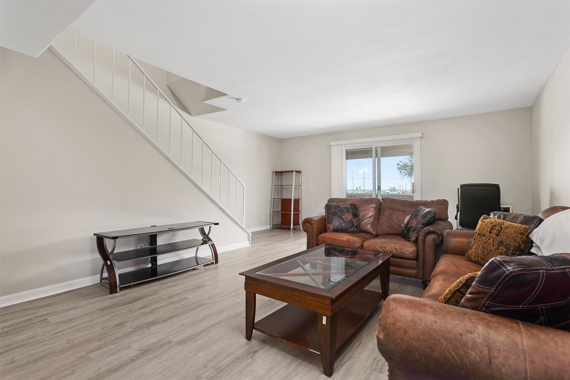 215 Postoffice Street, Unit 1208 Galveston, TX 77550 - Photo 2 of 19 a living room with furniture and a wooden floor