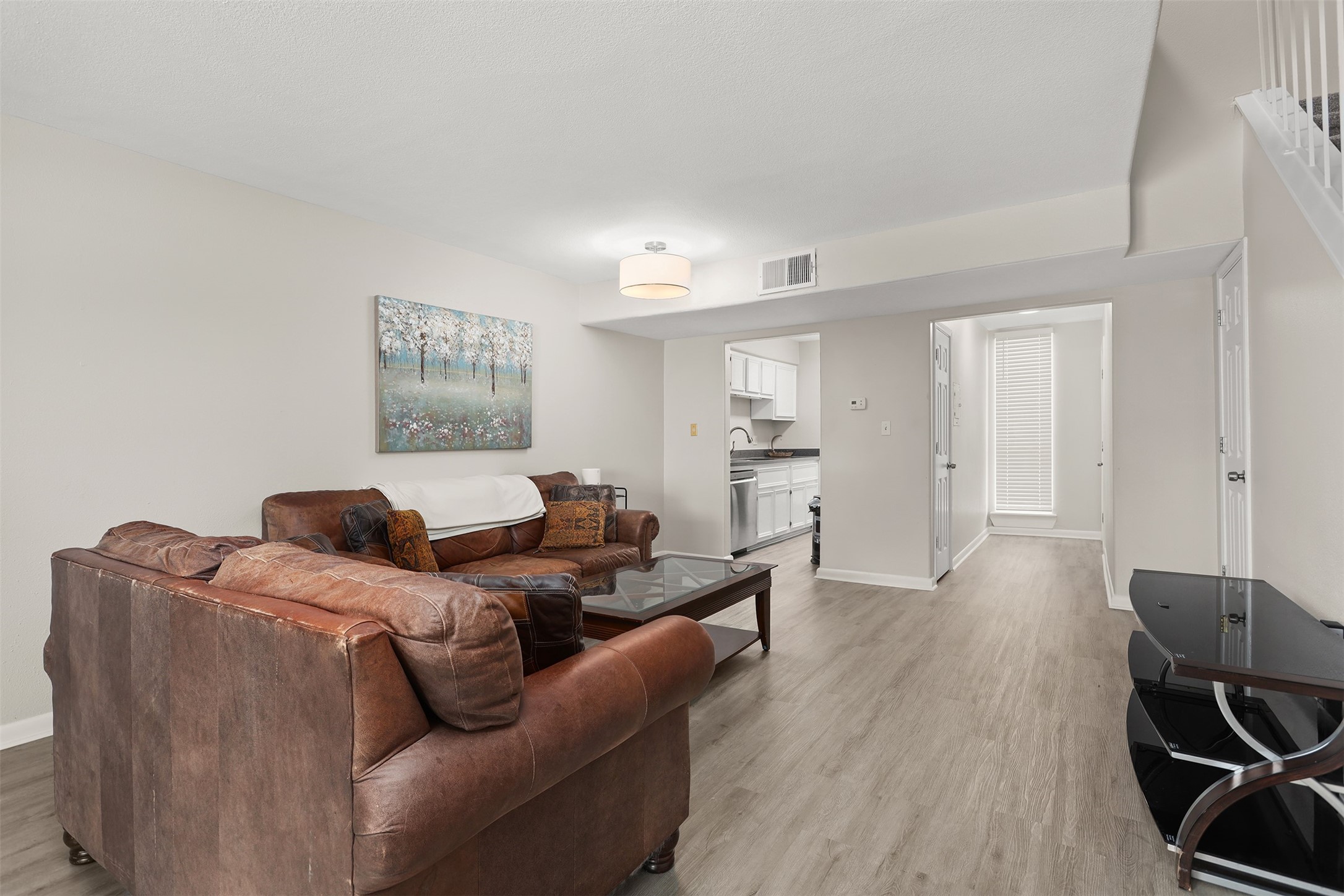 215 Postoffice Street, Unit 1208 Galveston, TX 77550 - Photo 3 of 19 a living room with furniture and a wooden floor