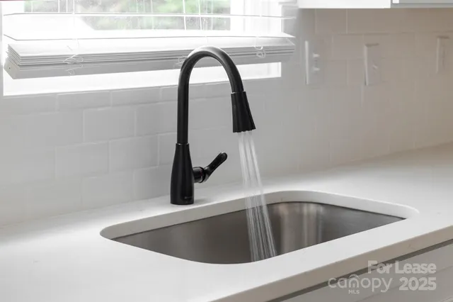 a view of a room with wooden floor and a window