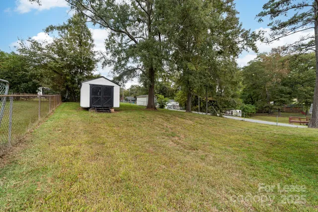 a view of a backyard with a garden and entertaining space