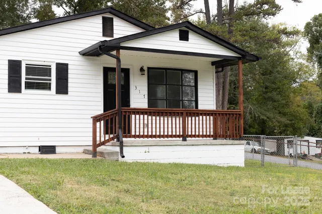 a view of a house with a wooden deck