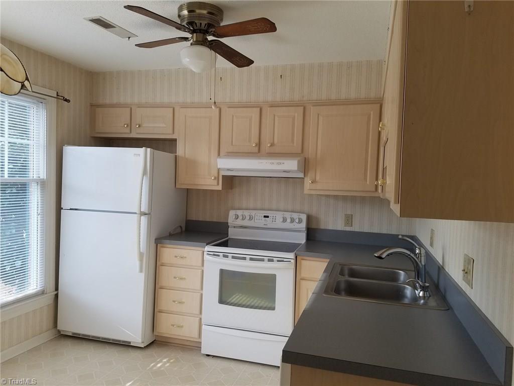 4917 B Tower Road Greensboro, NC 27410 - Photo 4 of 8 The Kitchen has two large windows, stainless steel double sink, and ample drawer and cabinet space. Not shown is pendant lighting above area for table. Space could also be used for portable island or additional storage.