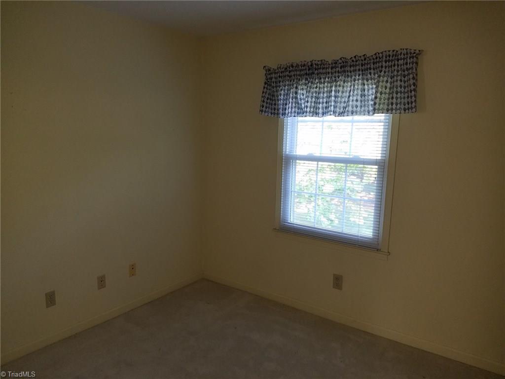 4917 B Tower Road Greensboro, NC 27410 - Photo 7 of 8 Bedroom 2 has upgraded carpet and padding and view to back yard.