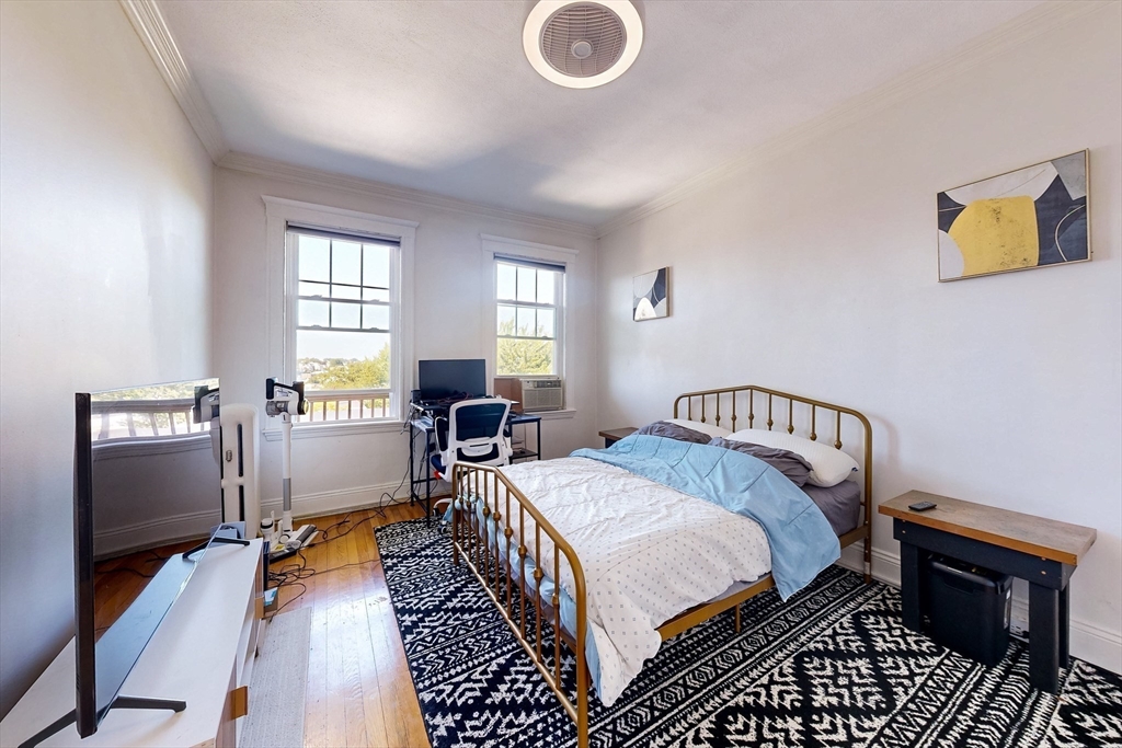 110 Bellingham Street, Unit 3 Chelsea, MA 02150 - Photo 13 of 26 a bedroom with a bed and wooden floor