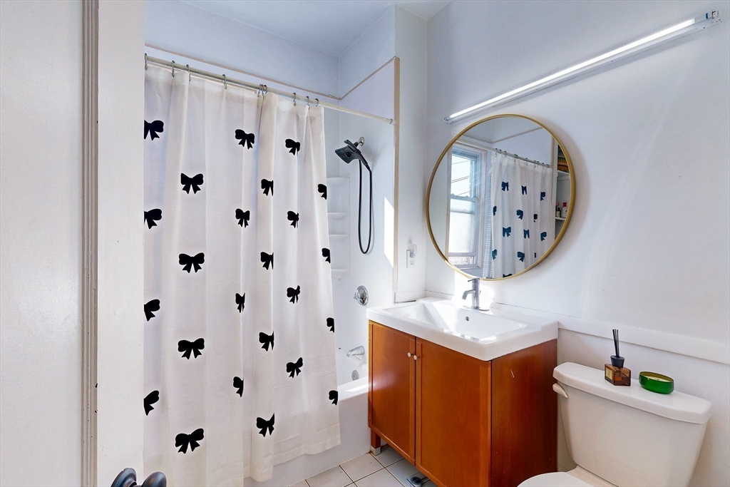 110 Bellingham Street, Unit 3 Chelsea, MA 02150 - Photo 21 of 26 a bathroom with a toilet a sink and a mirror