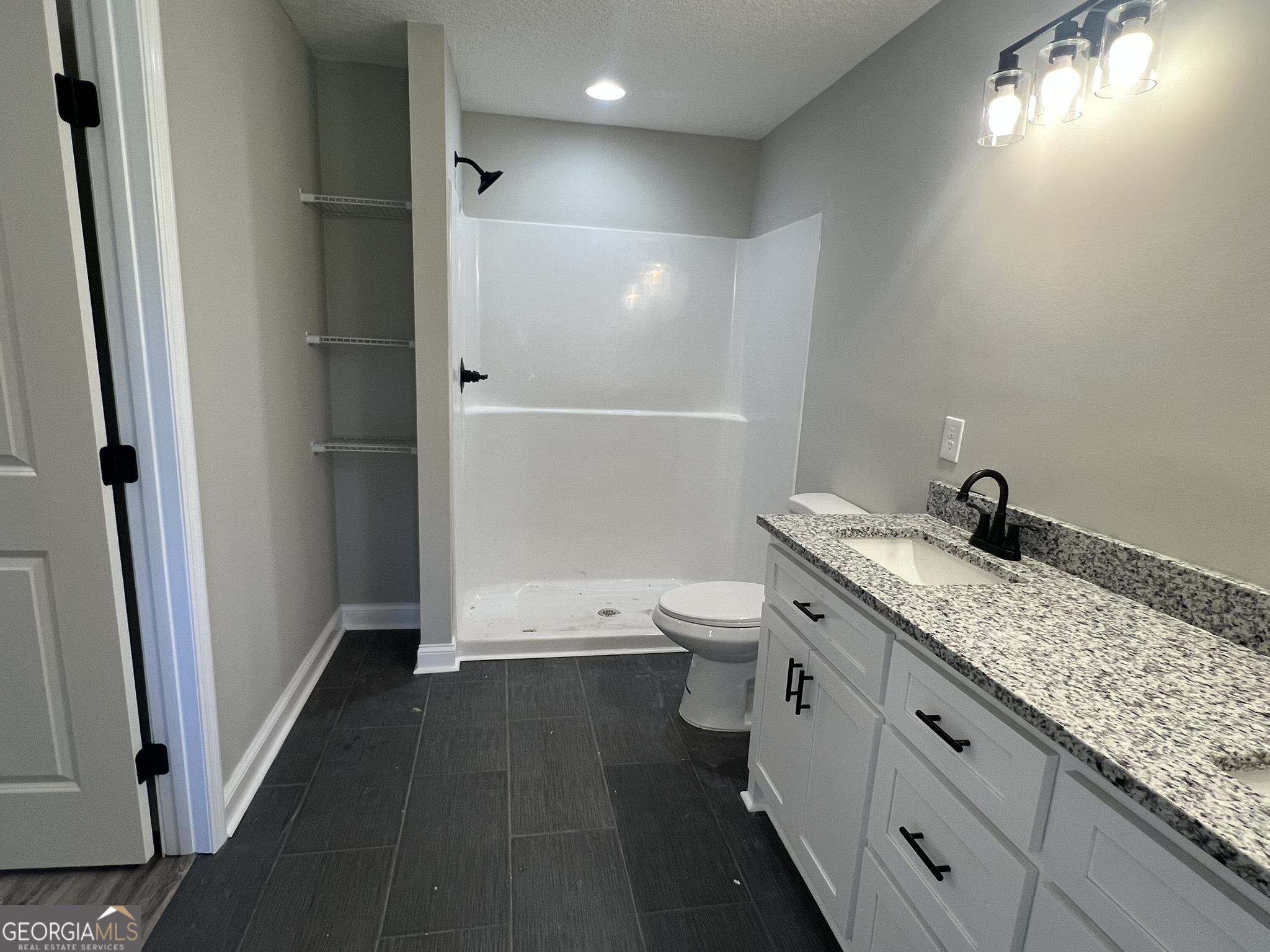 120 Caleb Circle Jesup, GA 31545 - Photo 11 of 22 a spacious bathroom with a granite countertop sink toilet and shower