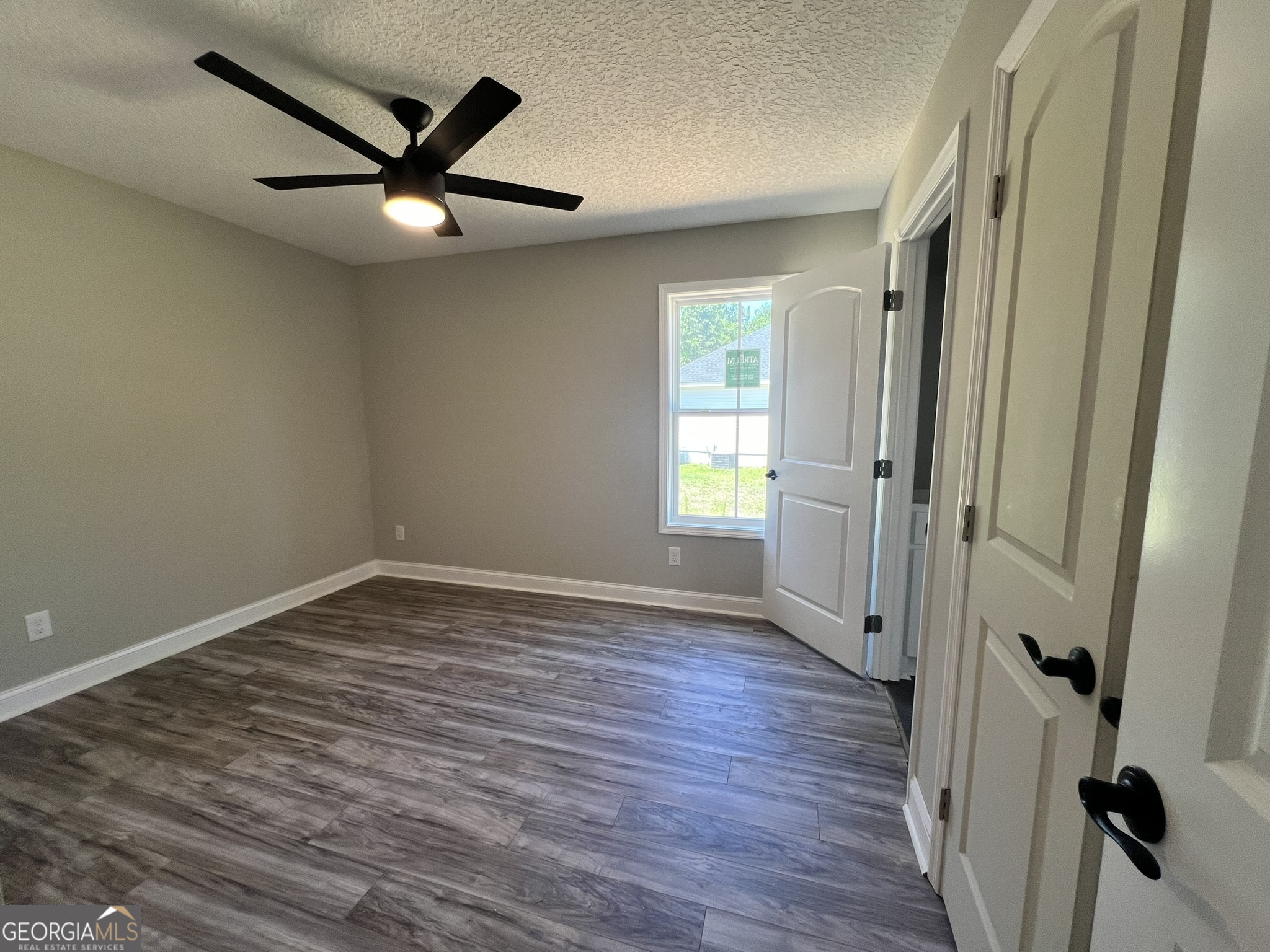 120 Caleb Circle Jesup, GA 31545 - Photo 14 of 22 an empty room with wooden floor and windows