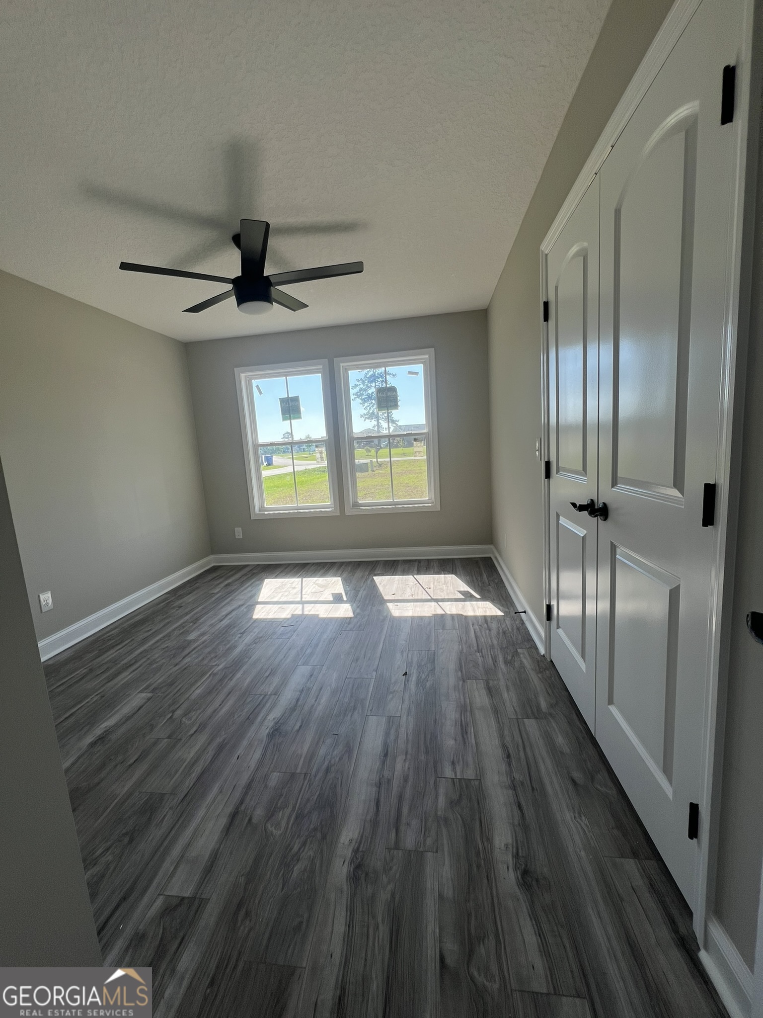 120 Caleb Circle Jesup, GA 31545 - Photo 17 of 22 a view of an empty room with wooden floor and a window
