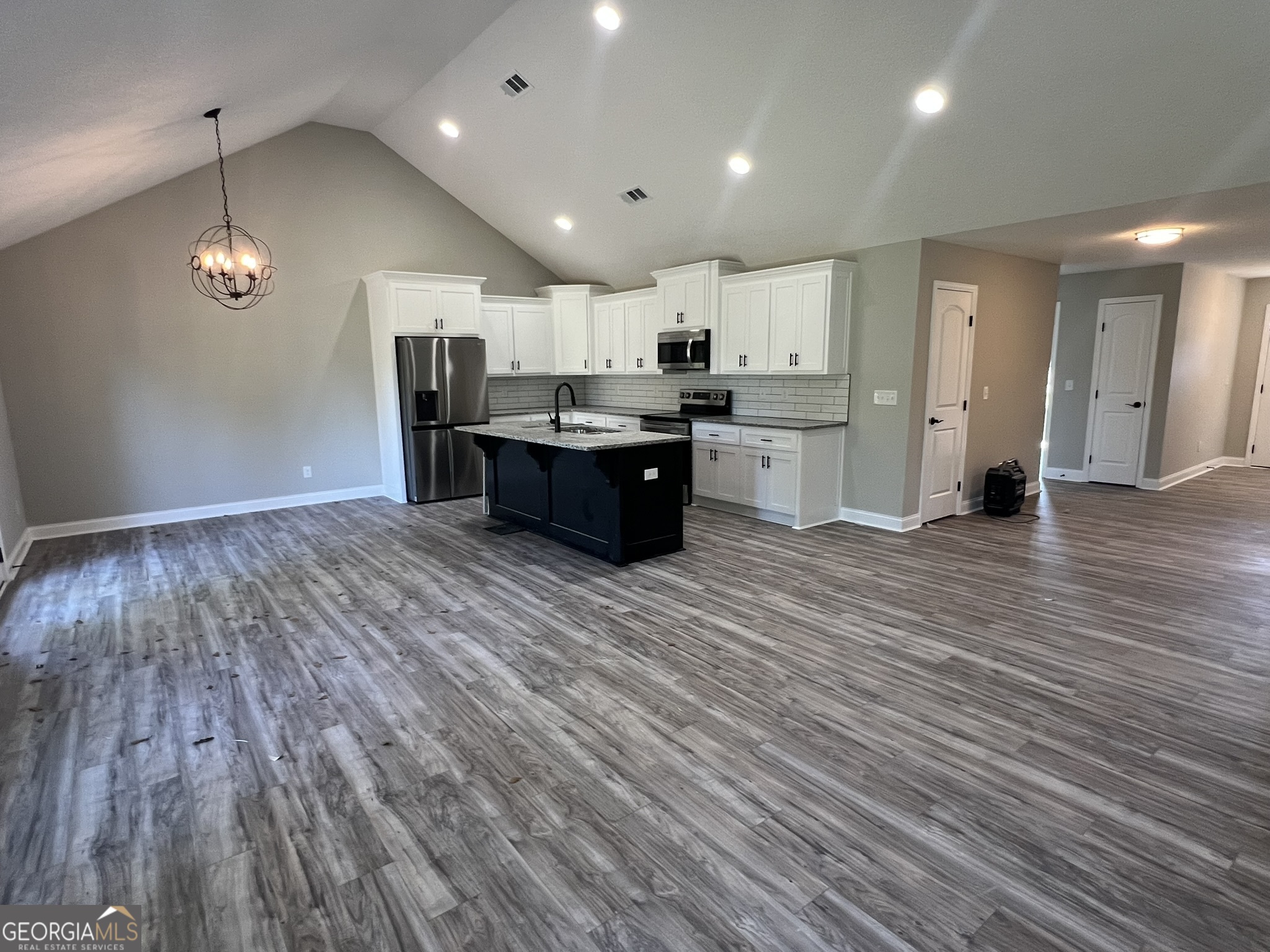 120 Caleb Circle Jesup, GA 31545 - Photo 7 of 22 a large room with a lot of cabinets and wooden floor