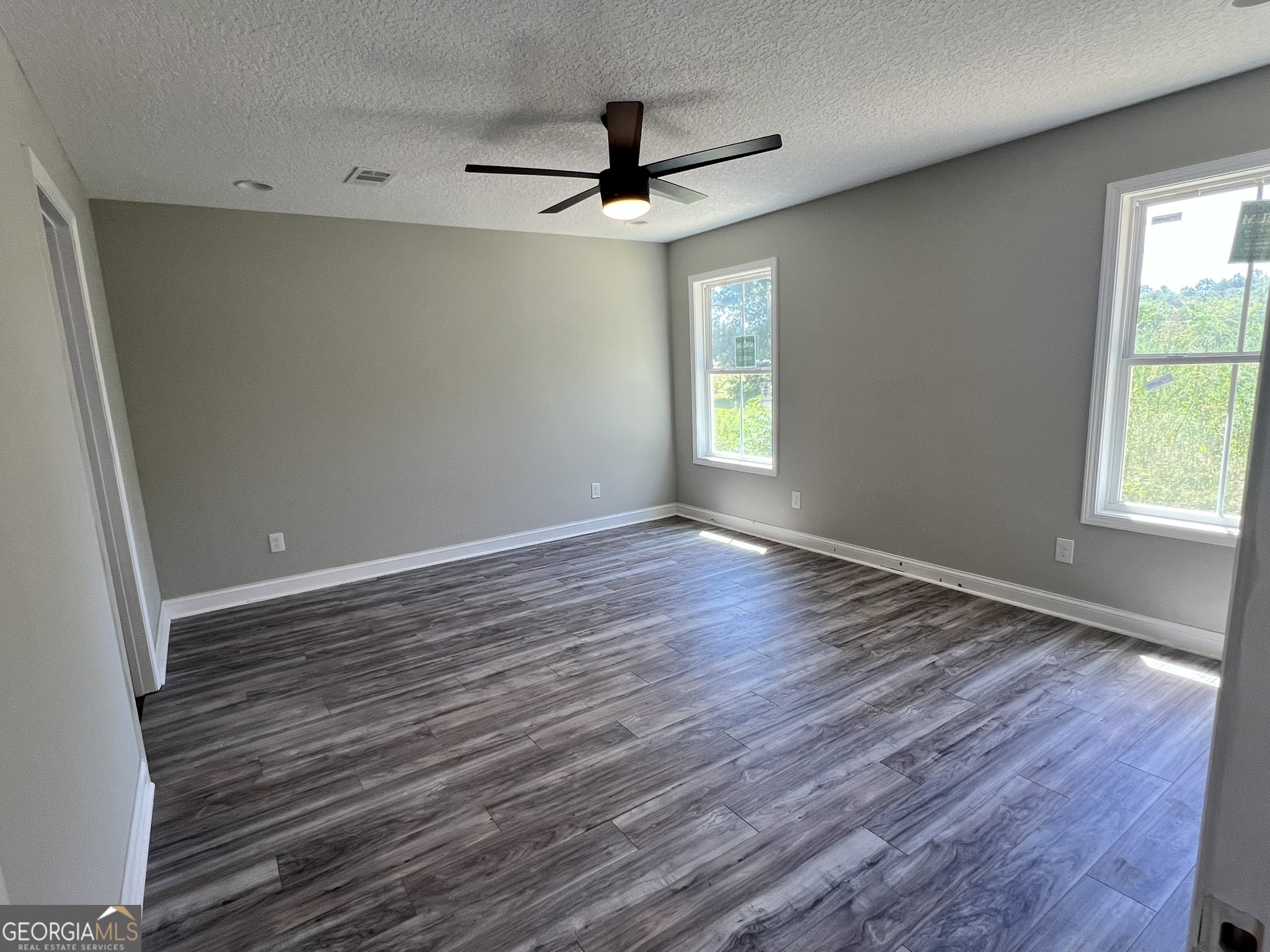 120 Caleb Circle Jesup, GA 31545 - Photo 10 of 22 wooden floor in an empty room with a window