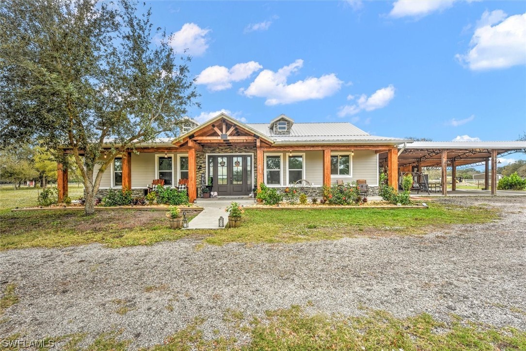 2010 Frontier Circle LaBelle, FL 33935 - Photo 1 of 35 a front view of a house with a yard table and chairs