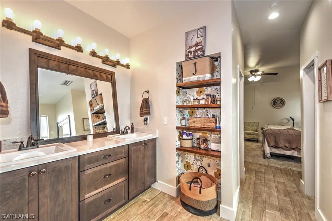 2010 Frontier Circle LaBelle, FL 33935 - Photo 15 of 35 a bathroom with double vanity and a mirror