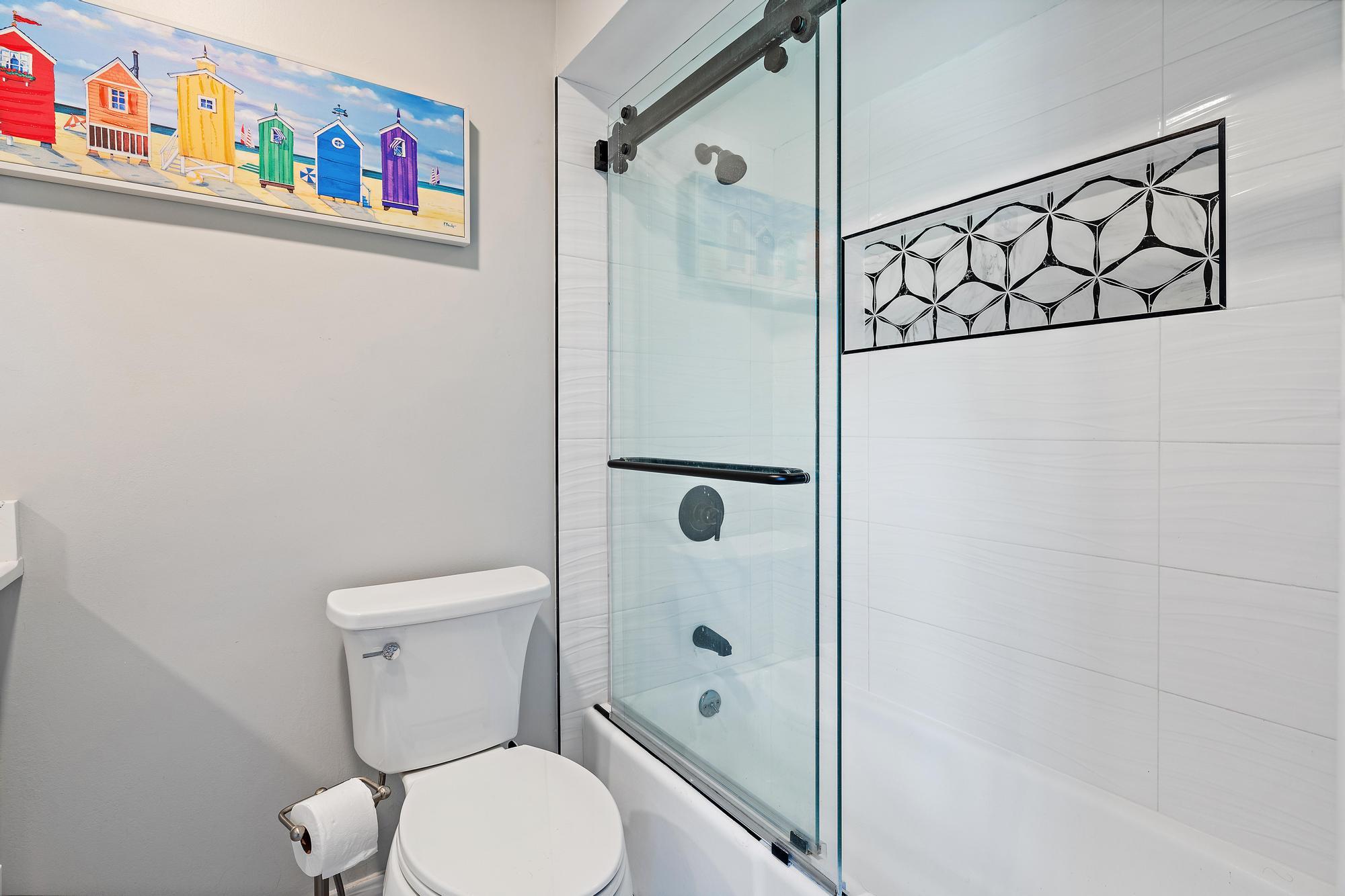 9170 Southeast Riverfront Terrace, Unit H Jupiter, FL 33469 - Photo 20 of 34 a white toilet sitting next to a bathroom sink