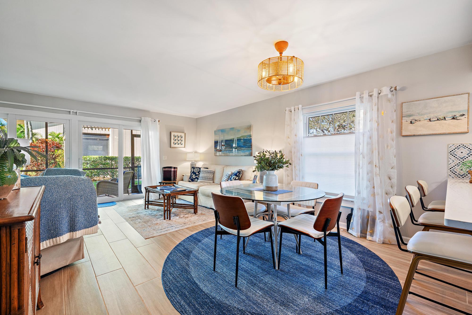 9170 Southeast Riverfront Terrace, Unit H Jupiter, FL 33469 - Photo 8 of 34 a view of a dining room with furniture window and wooden floor