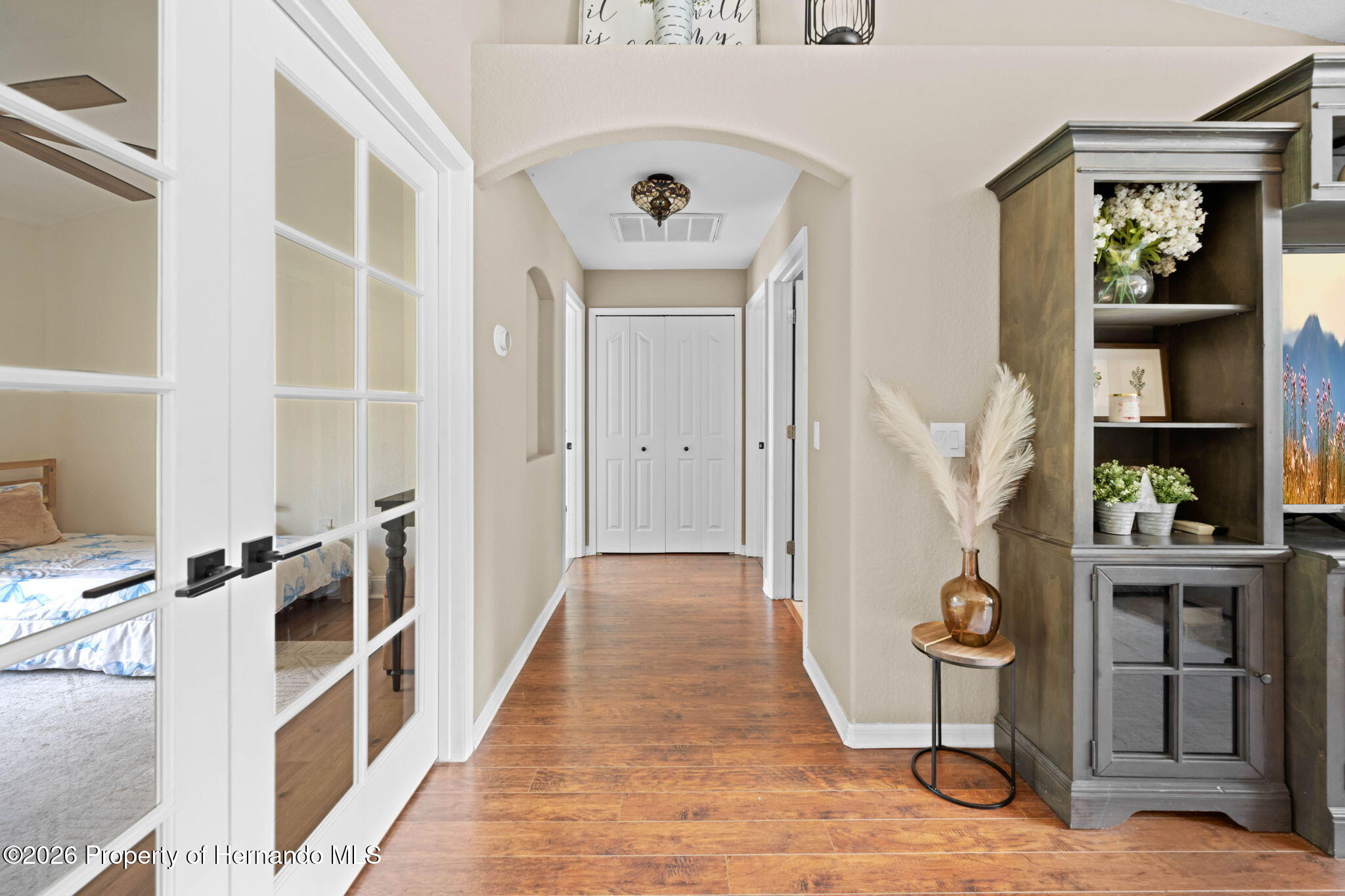 14220 Ermine Owl Road Brooksville, FL 34614 - Photo 34 of 54 a view of a hallway with wooden floor and entryway