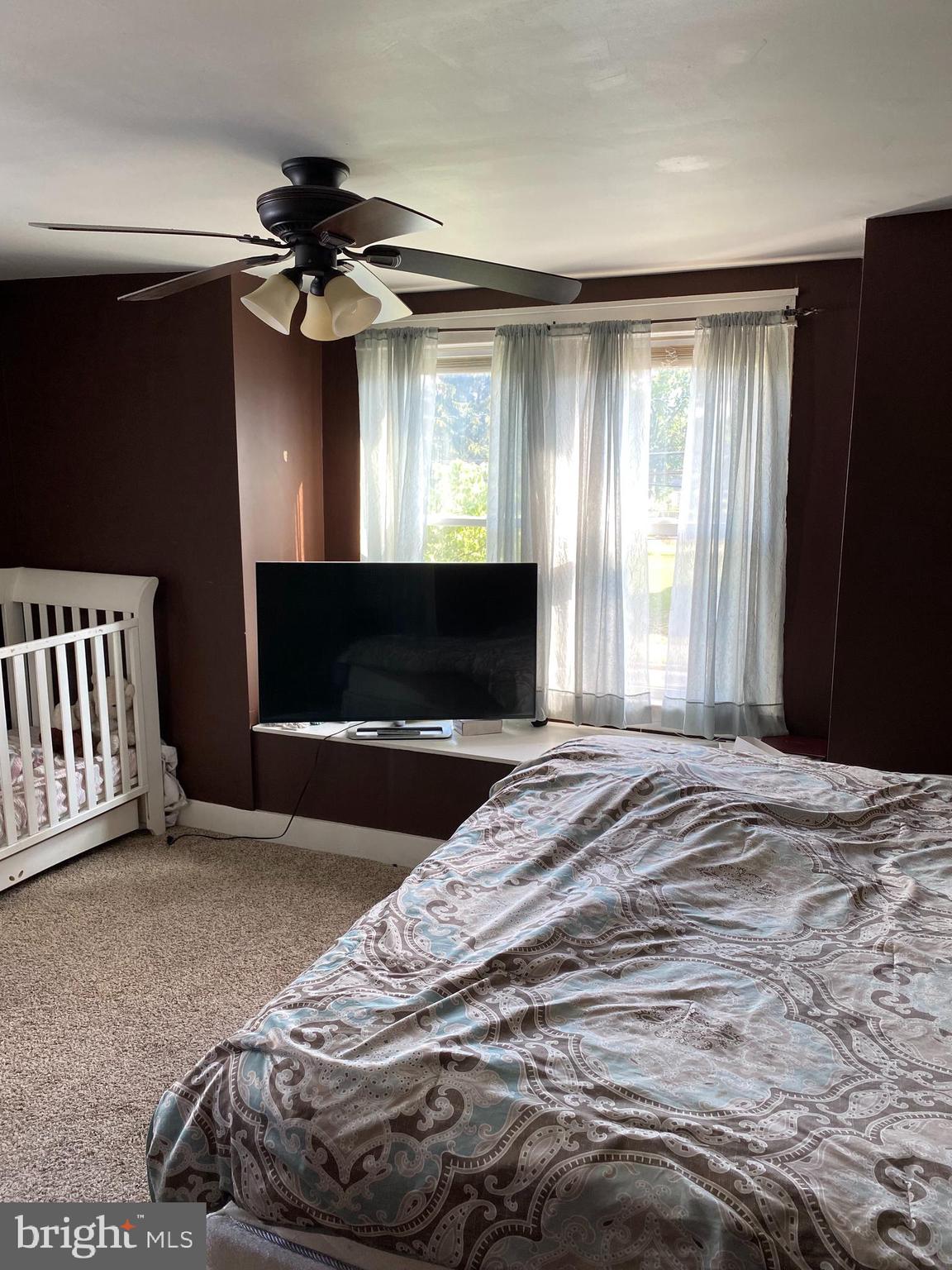 527 Bridgeboro Street Riverside, NJ 08075 - Photo 14 of 20 a bedroom with a bed and a flat tv screen