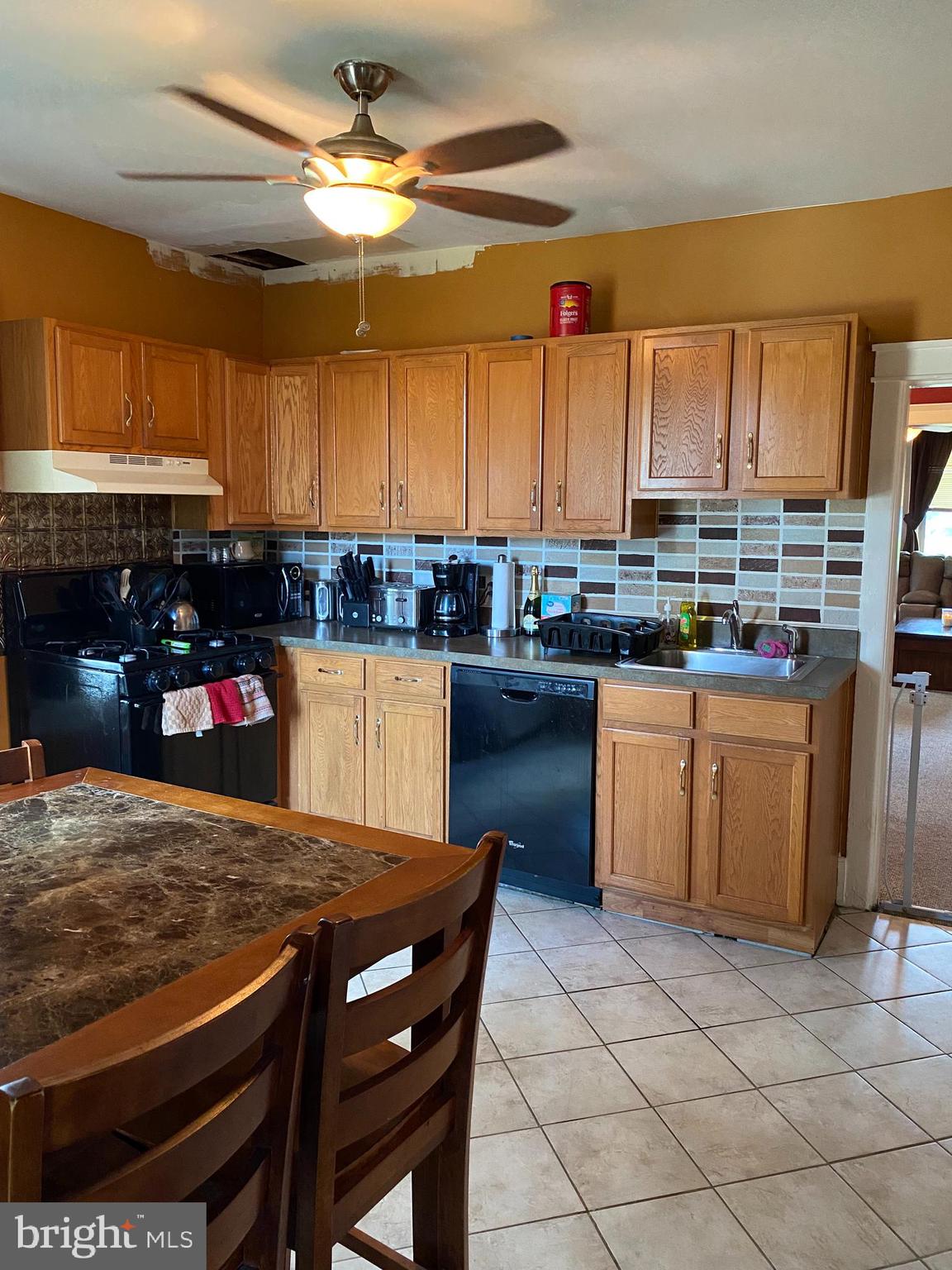 527 Bridgeboro Street Riverside, NJ 08075 - Photo 10 of 20 a kitchen with a stove a sink dishwasher and a refrigerator