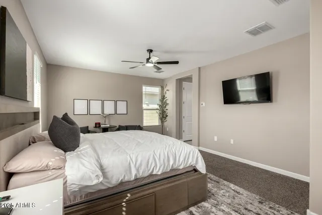 a bedroom with a bed and a flat screen tv