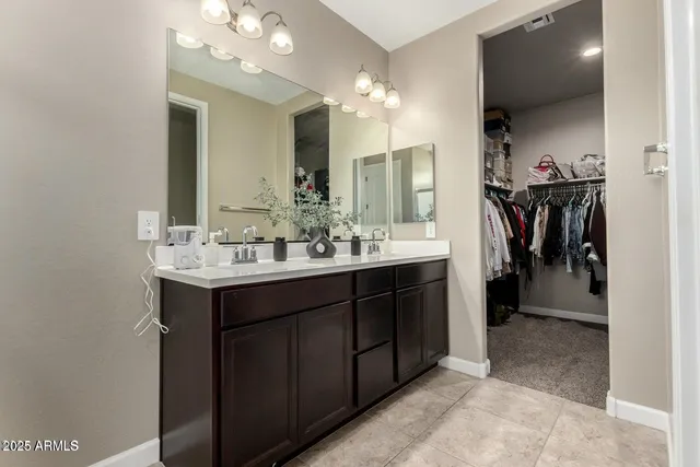 a bathroom with a sink vanity and a mirror