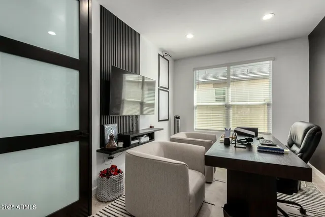 a room with a large window and furniture