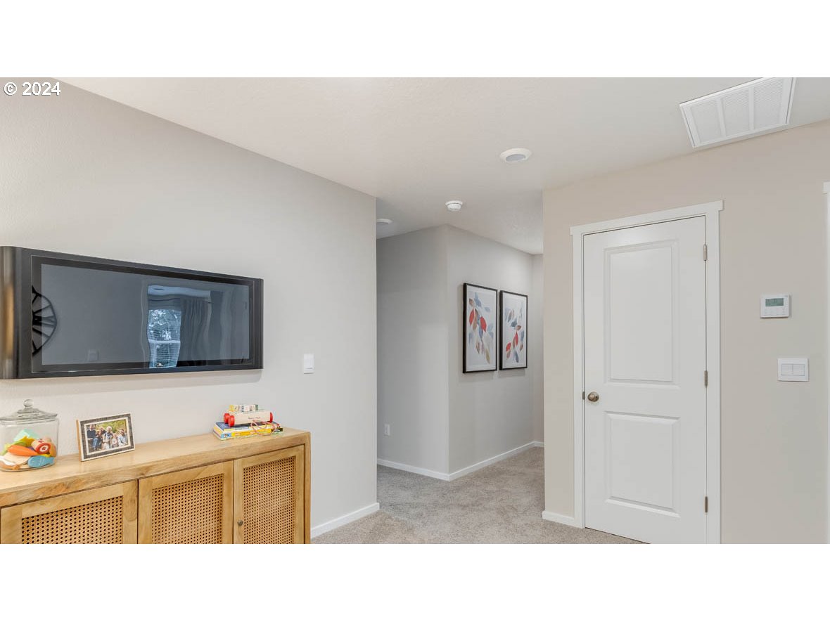 1463 Southeast Pheasant Avenue Gresham, OR 97080 - Photo 17 of 32 a room with a bed and a flat screen tv