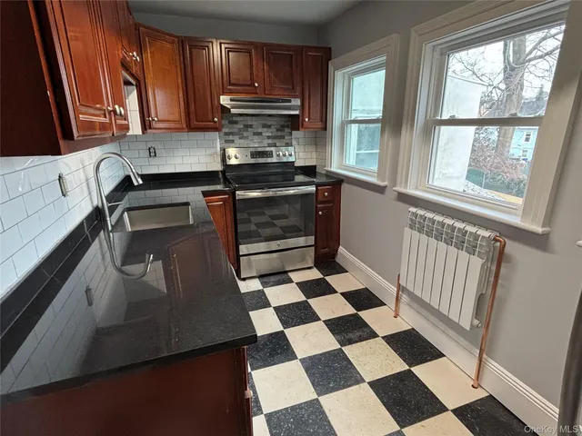 a kitchen with a stove a sink and a refrigerator