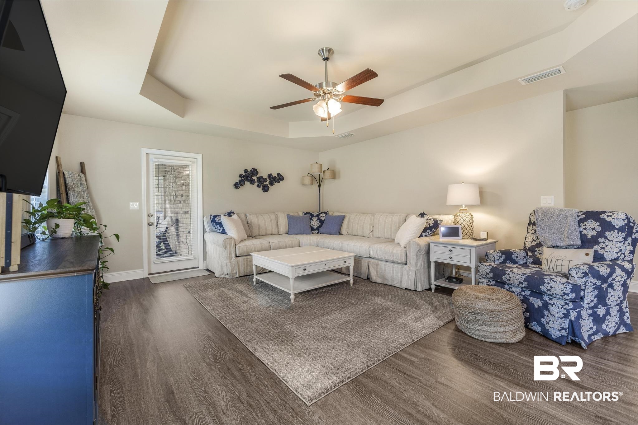 22043 Garland Loop Silverhill, AL 36576 - Photo 15 of 41 Living room featuring a tray ceiling, ceiling fan, and dark wood finished floors