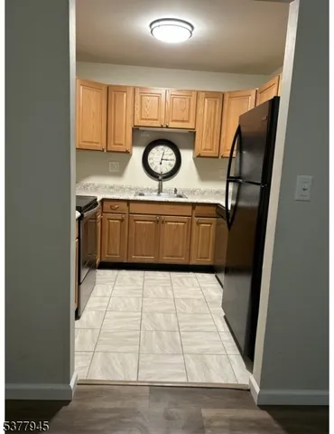 a bathroom with a granite countertop sink a washer and dryer