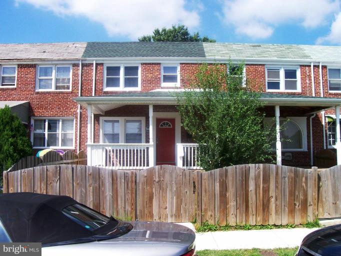 2462 Nevada Street Baltimore, MD 21230 - Photo 1 of 22 a view of a house with a small yard and wooden fence