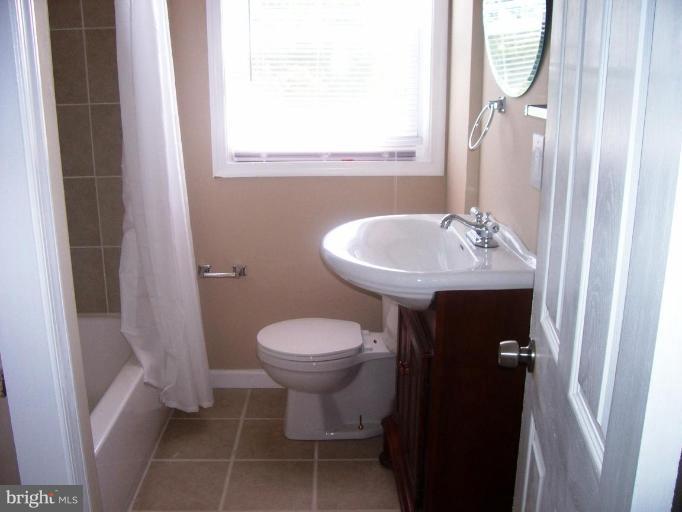 2462 Nevada Street Baltimore, MD 21230 - Photo 12 of 22 a bathroom with a sink toilet and mirror