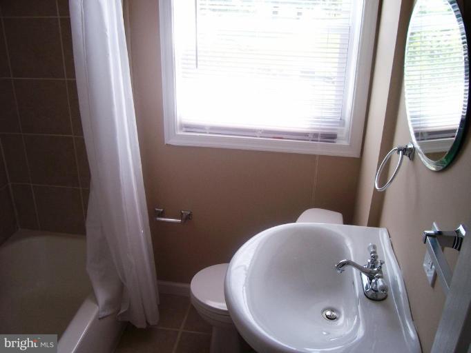 2462 Nevada Street Baltimore, MD 21230 - Photo 13 of 22 a bathroom with a sink and a toilet
