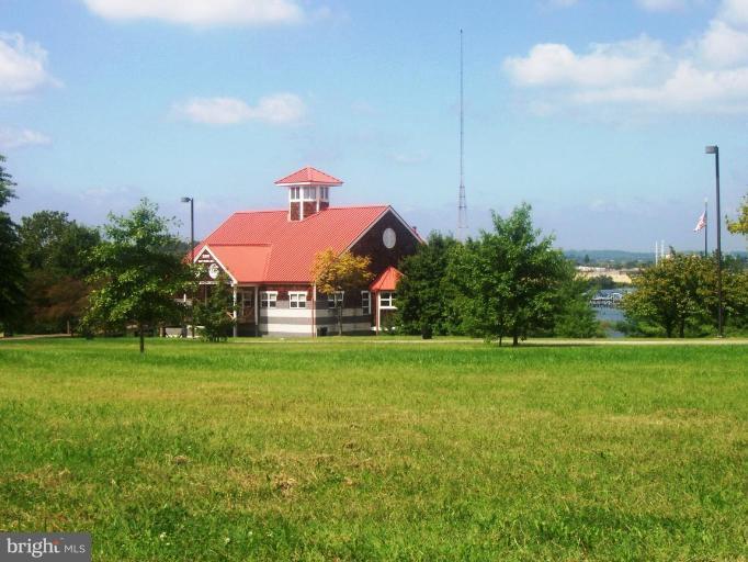 2462 Nevada Street Baltimore, MD 21230 - Photo 19 of 22 a front view of a house with a yard and garage